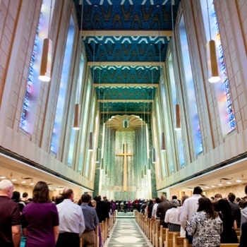 Chapel view from the back with people standing