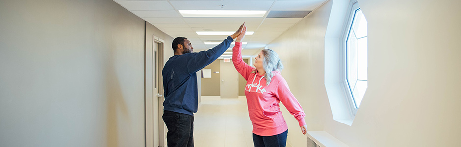 Two students high five