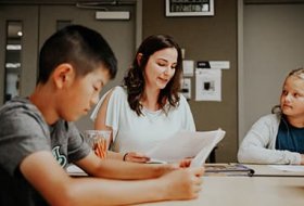 Teacher candidate and students reading