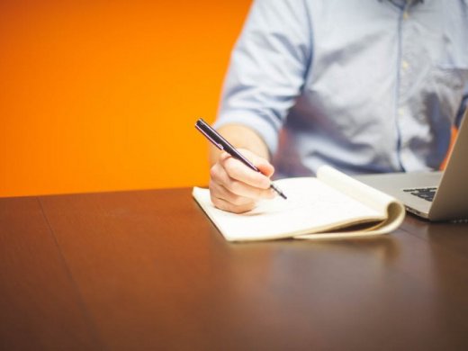 Man taking notes at a desk