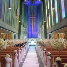 Chapel decorated with flowers along the pew