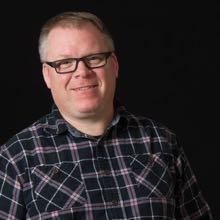 Andy Smith in front of a black background