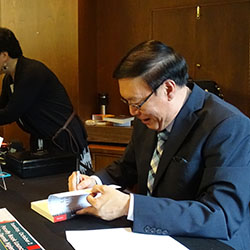 Dennis Ngien signing books